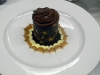 3 layered chocolate mousse cake with chocolate, vanilla cream and caramel sauces