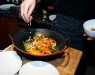 Adding almonds to the vegetable wok