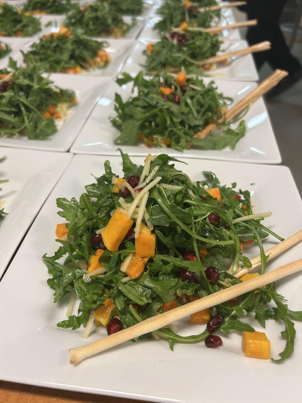 Plated salads lined up for service